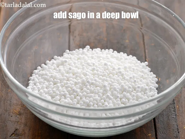 Step 14 – In a deep bowl, add 1/2 cup <a href="https://www.tarladalal.com/glossary-sago-sabudana-605i">sago (sabudana)</a>.