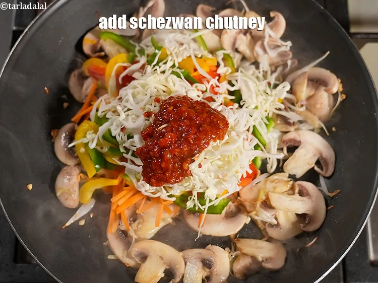 Step 14 – Add 2 tbsp <a href="https://www.tarladalal.com/glossary-schezwan-sauce-schezuan-sauce-1872i">schezwan chutney</a>.