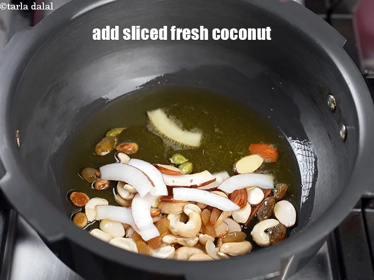 Step 14 – Add 8 to 10 <a href="https://www.tarladalal.com/glossary-coconut-nariyal-269i">sliced fresh coconut</a>.