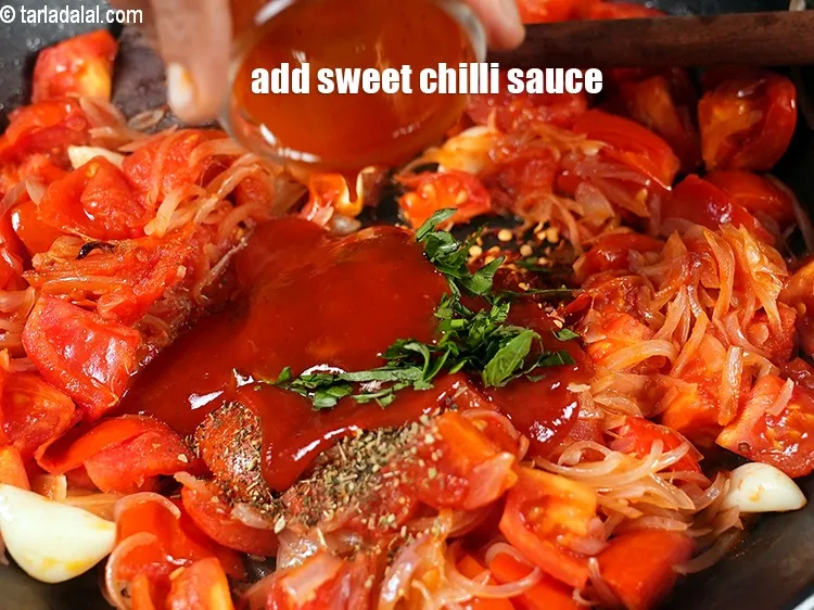 Step 14 – Add 2 tbsp&nbsp;<a href="https://www.tarladalal.com/glossary-sweet-chilli-sauce-1306i">sweet chilli sauce</a>.&nbsp;