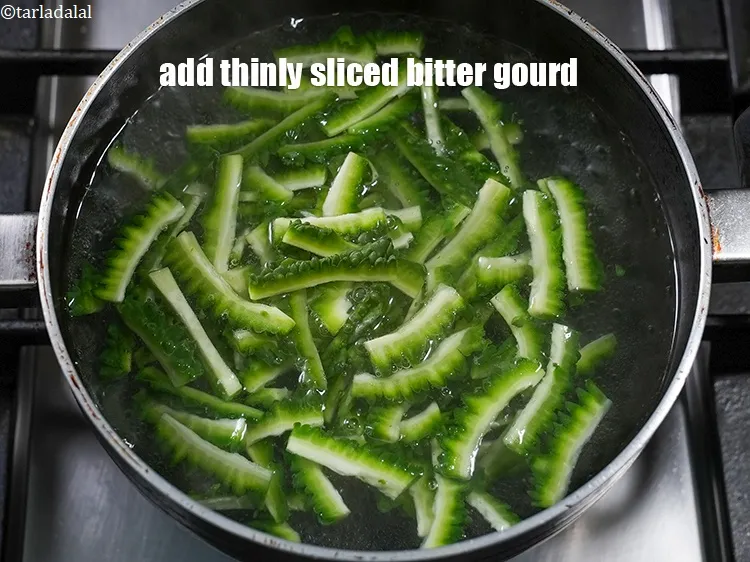 Step 14 – Add 2 cups thinly&nbsp;<a href="https://www.tarladalal.com/glossary-sliced-bitter-gourd-1145i">sliced bitter gourd (karela</a>).&nbsp;
