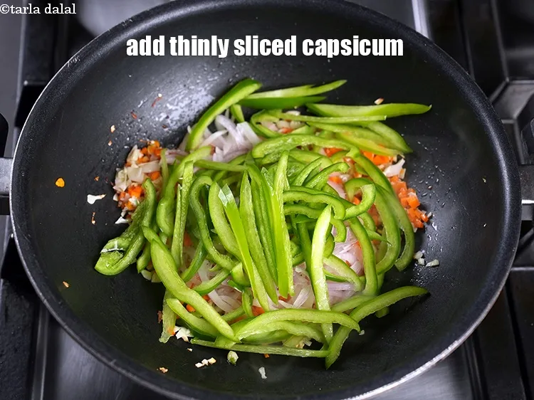 Step 19 – Add &frac34; cup thinly&nbsp;<a href="https://www.tarladalal.com/glossary-sliced-capsicum-165i">sliced capsicum</a>.