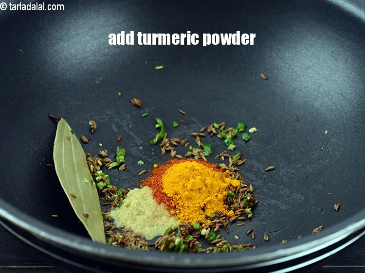 Step 14 – Add &frac14; tsp <a href="https://www.tarladalal.com/glossary-turmeric-powder-haldi-645i">turmeric powder (haldi)</a>.