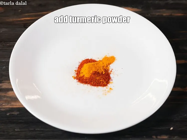 Step 14 – Add &frac14; tsp&nbsp;<a href="https://www.tarladalal.com/glossary-turmeric-powder-haldi-645i">turmeric powder (haldi)</a>.