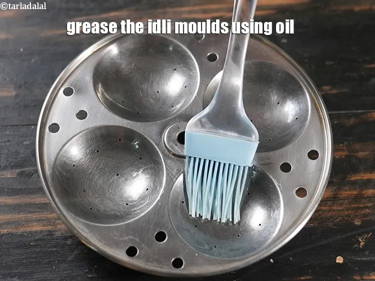 Step 14 – Grease the idli moulds using oil.