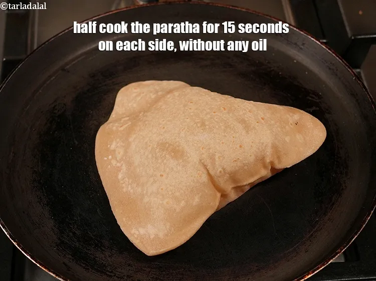 Step 17 – Half cook the paratha for 15 seconds on each side, without any oil.
