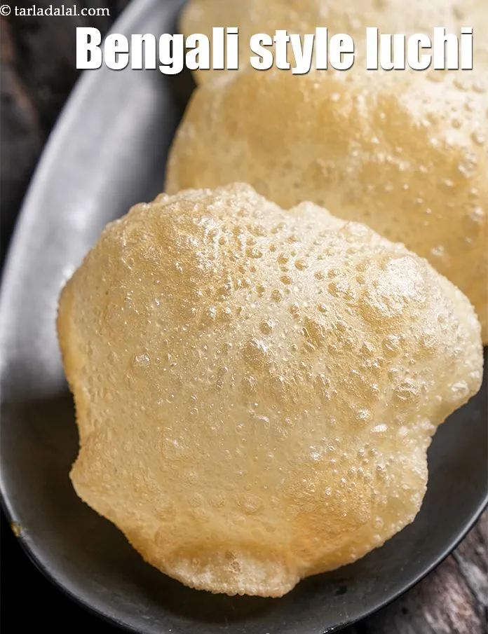 स्टेप 14 – <strong>लुची को</strong>&nbsp;अपनी पसंद की सब्जी के साथ गरमा गरम&nbsp;परोसें ।