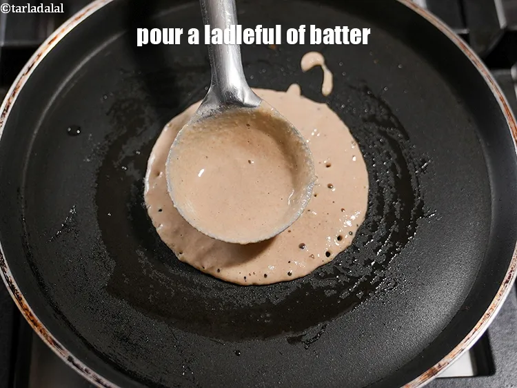 Step 21 – <meta charset="UTF-8" />Pour a ladleful of batter over it. Spread in a circular motion to …