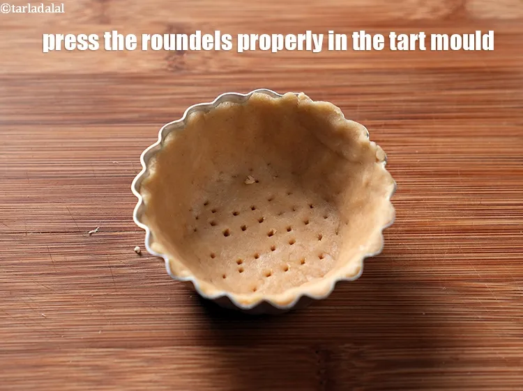 Step 14 – Place each roundel in the tart mould and press it properly from all the sides.