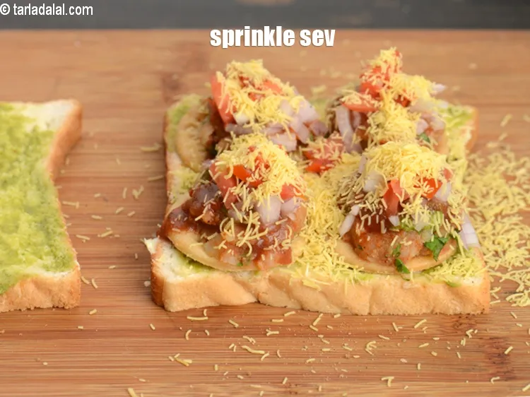 Step 15 – Sprinkle 1 tsp of <a href="https://www.tarladalal.com/glossary-sev-1137i">sev</a> evenly over each papdi.&nbsp;
