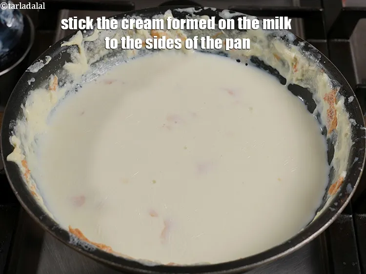 Step 14 – Stick the cream (malai) formed on the milk to the sides of the pan.