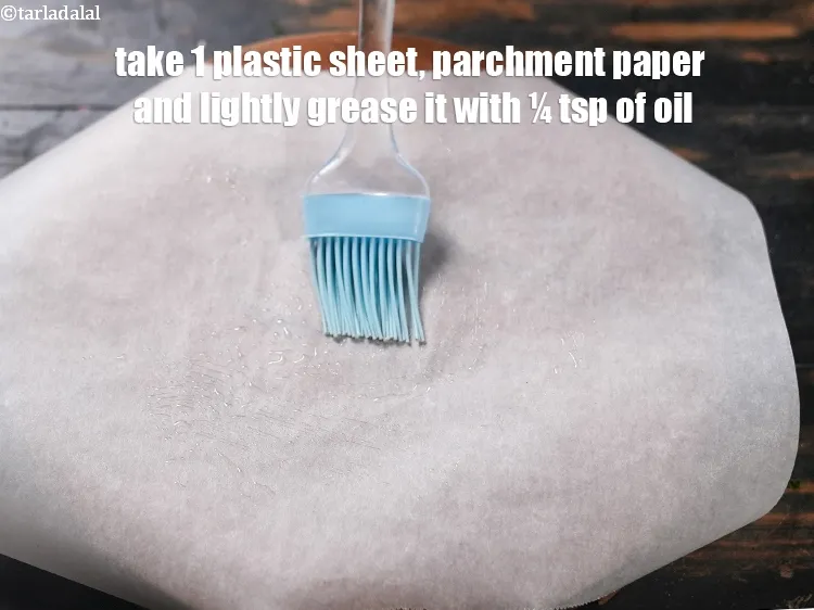 Step 14 – Take 1 plastic sheet/parchment paper and lightly grease it with &frac14; tsp of oil.