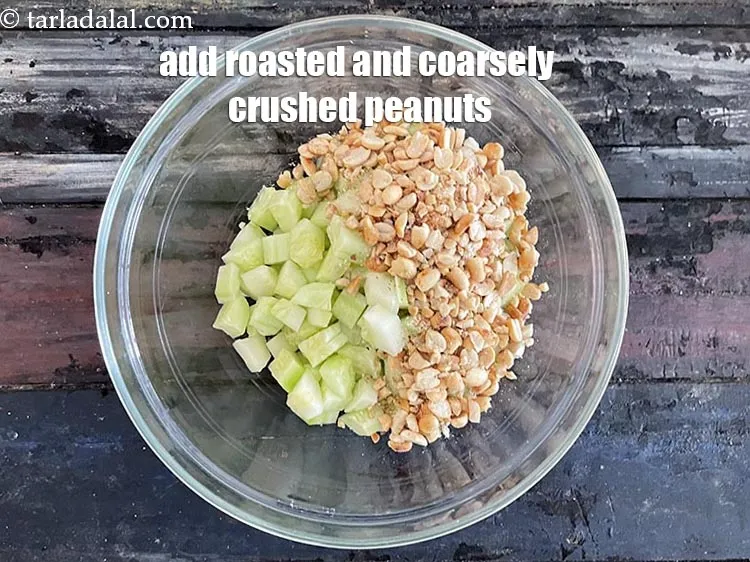 Step 16 – Add&nbsp;1/2 cup&nbsp;<a href="https://tarladalal.com/glossary-roasted-and-crushed-peanuts-1817i">roasted and coarsely crushed peanuts</a>.