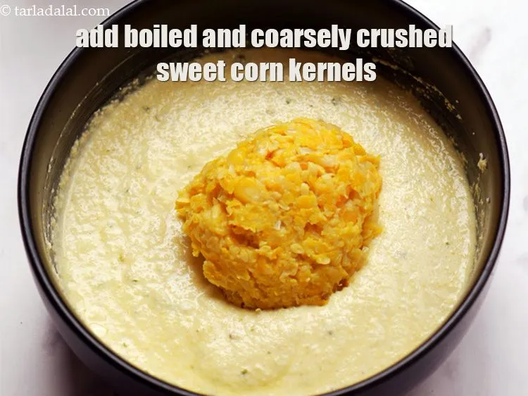 Step 14 – Add 1/2 cup&nbsp;boiled and coarsely&nbsp;<a href="https://www.tarladalal.com/glossary-crushed-sweet-corn-kernels-1605i">crushed sweet corn kernels (makai ke dane)</a>.&nbsp;