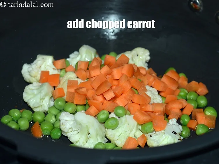 Step 15 – Add &frac14; cup <a href="https://www.tarladalal.com/glossary-chopped-carrot-798i">chopped carrot</a>.