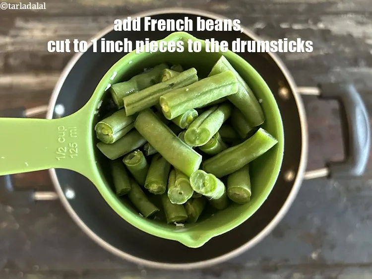 Step 14 – Add&nbsp;<!--%3Cmeta%20charset%3D%22UTF-8%22%20%2F%3E-->1/2 cup&nbsp;long&nbsp;<a href="glossary-french-beans-fansi-196i">french beans</a>&nbsp;, cut into 25 mm. (1") pieces to the semi cooked drumsticks. …