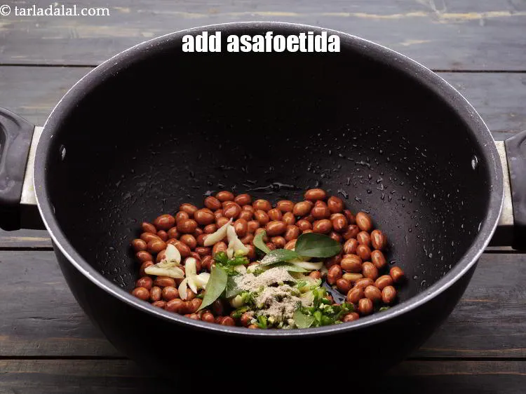 Step 13 – Add <a href="https://www.tarladalal.com/glossary-asafoetida-hing-113i" target="_blank">asafoetida</a>.