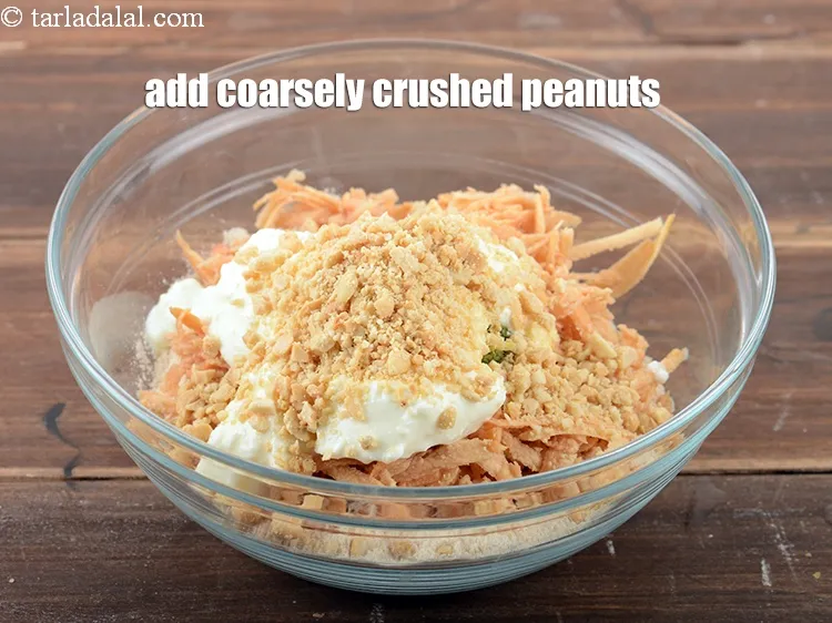 Step 14 – Add &frac14; cup coarsely <a href="https://www.tarladalal.com/glossary-crushed-raw-peanuts-917i">crushed peanuts</a>.