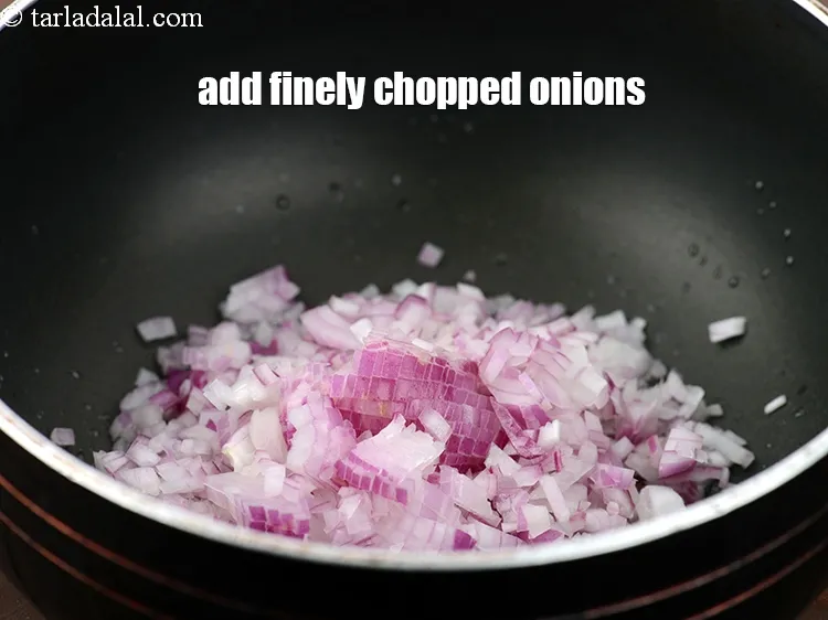 Step 18 – When the seeds crackle, add 3/4 cup&nbsp;finely&nbsp;<a href="https://www.tarladalal.com/glossary-chopped-onions-722i">chopped onions</a>.