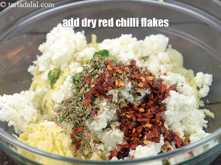 Step 14 – Add 1 tsp <a href="https://www.tarladalal.com/glossary-dry-red-chilli-flakes-paprika-338i">dry red chilli flakes (paprika)</a>.