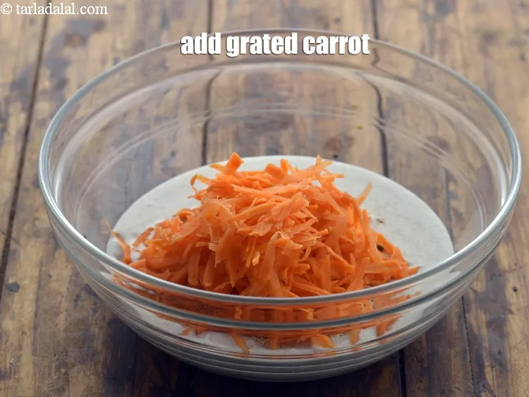 Step 13 – Add grated carrot. Other vegetables like grated beetroot, doodhi, mooli can also be used.
