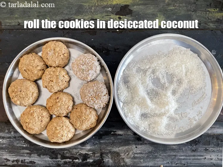 Step 16 – Roll the prepared cookies in desiccated coconut till they are evenly coated from both the …
