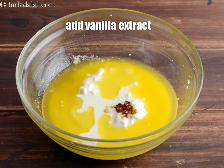 Step 15 – Add the&nbsp;milk mixture and &frac12; tsp <a href="https://www.tarladalal.com/glossary-vanilla-extract-1248i">vanilla extract</a>.