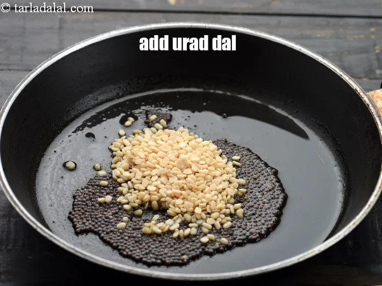 Step 15 – When the seeds crackle, add 2 tsp&nbsp;<a href="https://www.tarladalal.com/glossary-urad-dal-split-black-lentil-941i">urad dal (split black lentils)</a>.&nbsp;