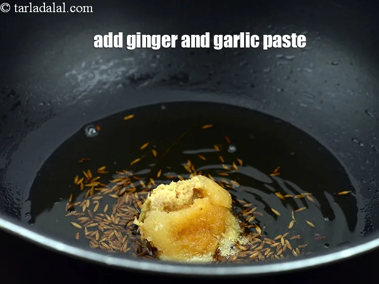Step 14 – When the cumin seeds crackle, add 1 tbsp <a href="https://www.tarladalal.com/glossary-ginger-adrak-453i">ginger (adrak)</a>&nbsp;<a href="https://www.tarladalal.com/glossary-garlic-paste-lehsun-ki-paste-lahsun-ki-paste-350i">garlic (lehsun) paste</a>.