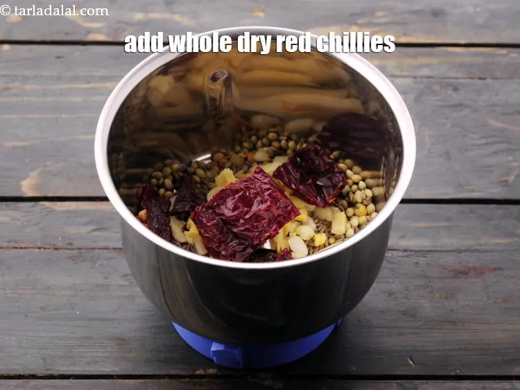 Step 21 – Add the <a href="https://www.tarladalal.com/glossary-whole-dry-kashmiri-red-chillies-kashmiri-mirch-kashmiri-lal-mirch-332i" target="_blank">whole dry red chillies</a>.