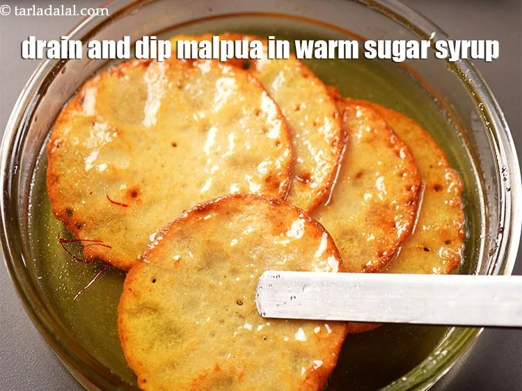 Step 20 – Drain well and dip each malpua in warm sugar syrup for 2 to 3 minutes.