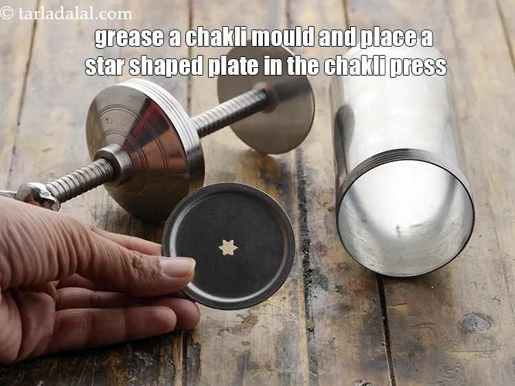 Step 37 – <meta charset="UTF-8" />Grease a&nbsp;<strong>chakli</strong>&nbsp;mould and place a star shaped plate in the chakli press. This …