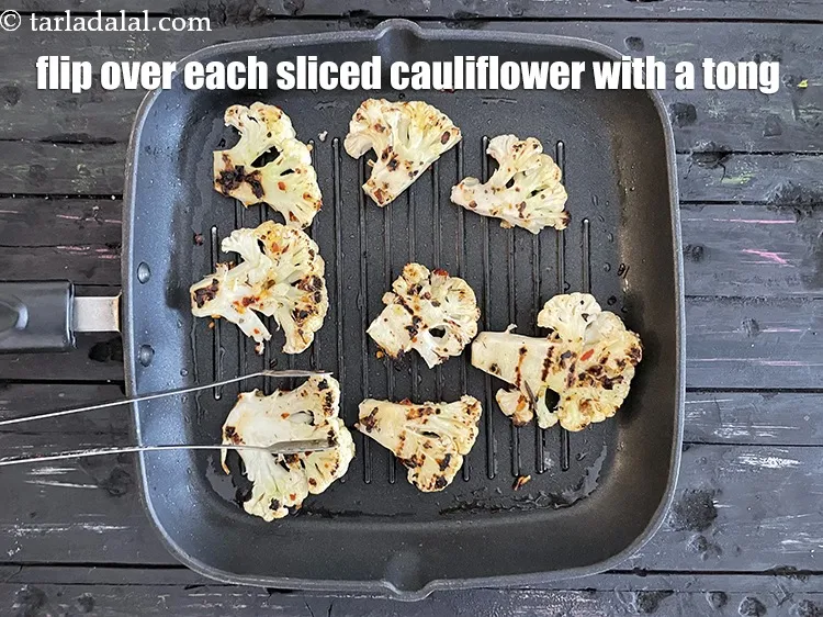 Step 16 – Turn each marinated cooked cauliflower over using a tong.