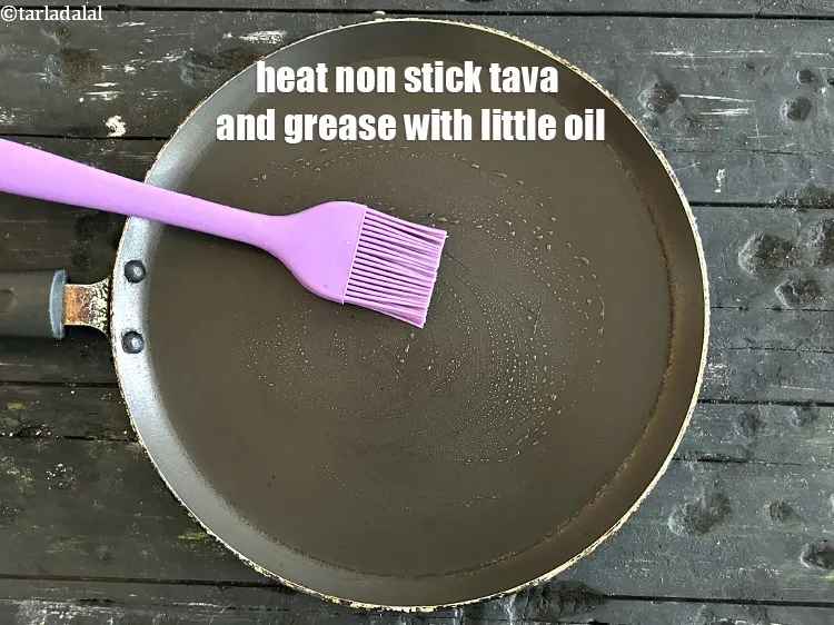 Step 16 – <meta charset="UTF-8" />Heat a non-stick tava (griddle) and grease it lightly with &frac14; tsp of …