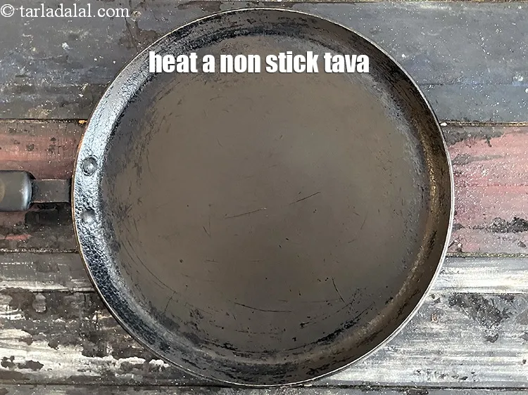 Step 13 – <meta charset="UTF-8" />Heat a non-stick tava (griddle).