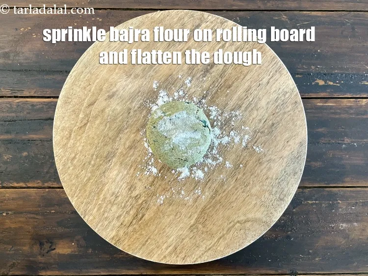 Step 14 – Sprinkle a little bajra flour&nbsp;on the rolling surface.&nbsp;Flatten the dough between your palms and place …