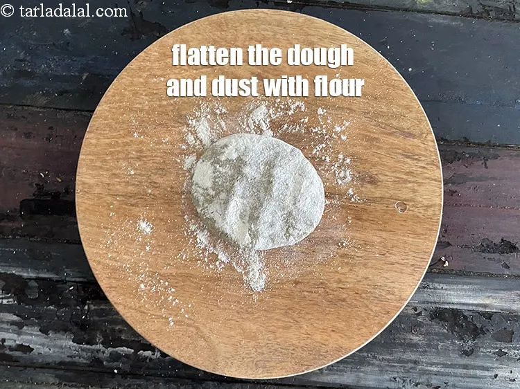 Step 15 – <meta charset="UTF-8" />Place a portion of the dough on it and flatten it.&nbsp;&nbsp;