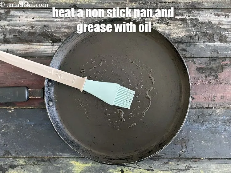 Step 16 – <meta charset="UTF-8" /> Heat a non-stick tava (griddle) and grease it with &frac14; tsp of …