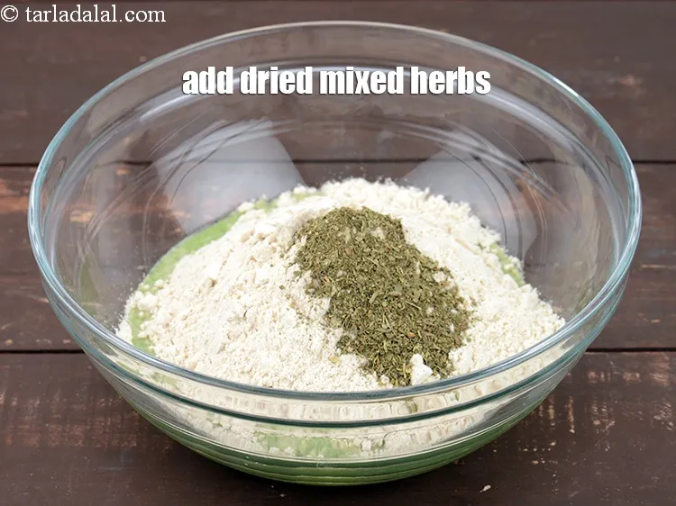 Step 14 – Add 1 tsp <a href="https://www.tarladalal.com/glossary-dried-mixed-herbs-466i">dried mixed herbs</a>.