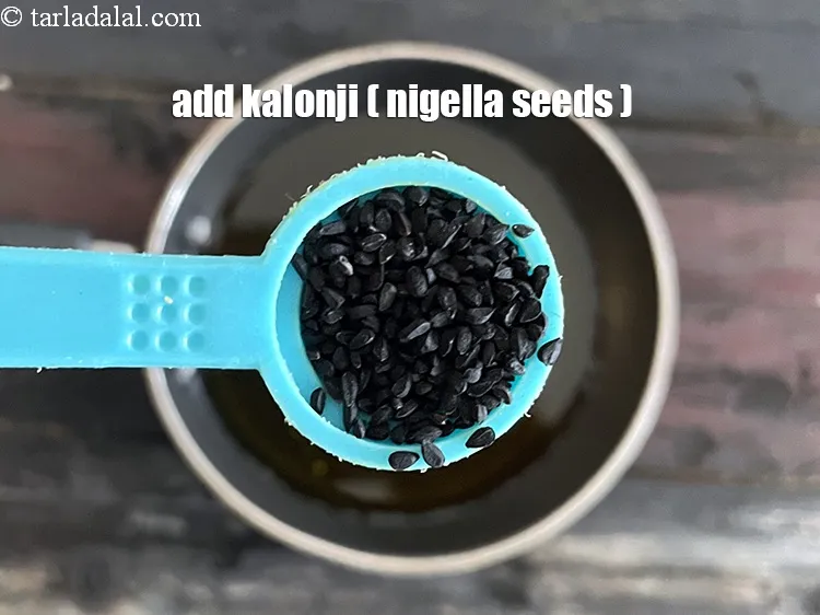 Step 22 – Once the oil is warm, add 1/2 tsp&nbsp;<a href="https://tarladalal.com/glossary-nigella-seeds-kalonji-onion-seeds-552i">nigella seeds (kalonji)</a>.