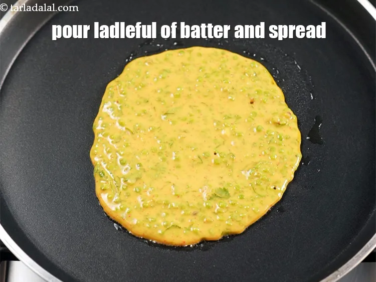 Step 14 – Pour a ladleful of the batter on it and spread it in a circular motion …