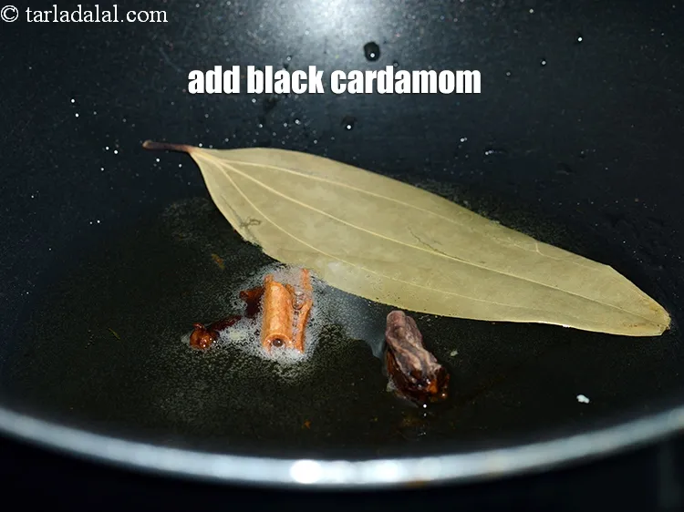 Step 14 – Add 1 <a href="https://www.tarladalal.com/glossary-black-cardamom-badi-elaichi-moti-elaichi-263i">black cardamom (badi elaichi)</a>.