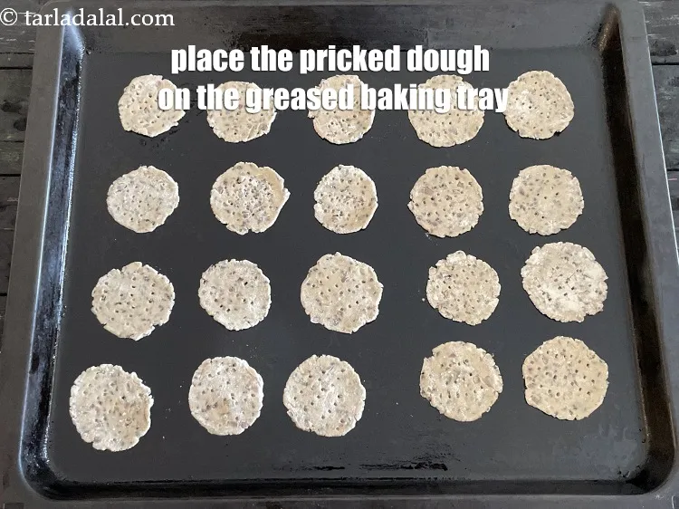 Step 16 – <p>Place the pricked dough on the baking tray. We put 20 puris on one big …