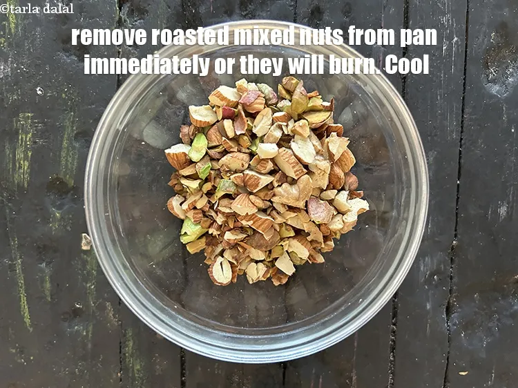 Step 14 – <meta charset="UTF-8" />Remove&nbsp;<strong>roasted mixed nuts</strong>&nbsp;from pan immediately or they will burn. Cool.&nbsp;