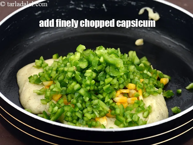 Step 14 – Add 1/2 cup&nbsp;finely&nbsp;<a href="https://www.tarladalal.com/glossary-chopped-capsicum-164i">chopped capsicum</a>.&nbsp;
