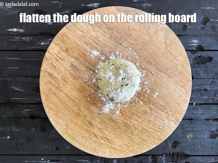 Step 15 – <meta charset="UTF-8" />Place a portion of dough ball on rolling board and press it.&nbsp;&nbsp;&nbsp;<br /> …