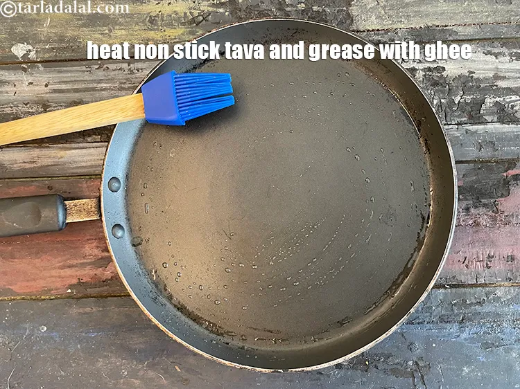 Step 15 – <meta charset="UTF-8" /> <meta charset="UTF-8" />Heat a non-stick tava (griddle) and grease with ghee.&nbsp;