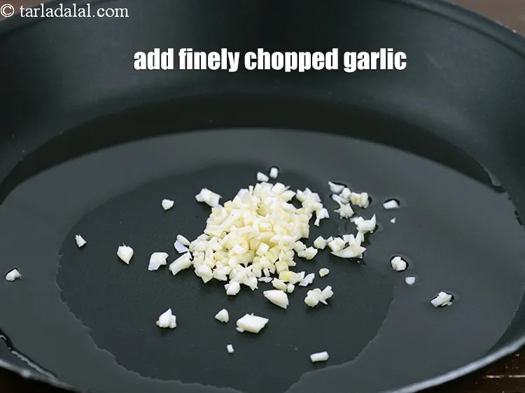 Step 14 – Add 1 tbsp finely <a href="https://www.tarladalal.com/glossary-chopped-garlic-790i">chopped garlic (lehsun)</a>.