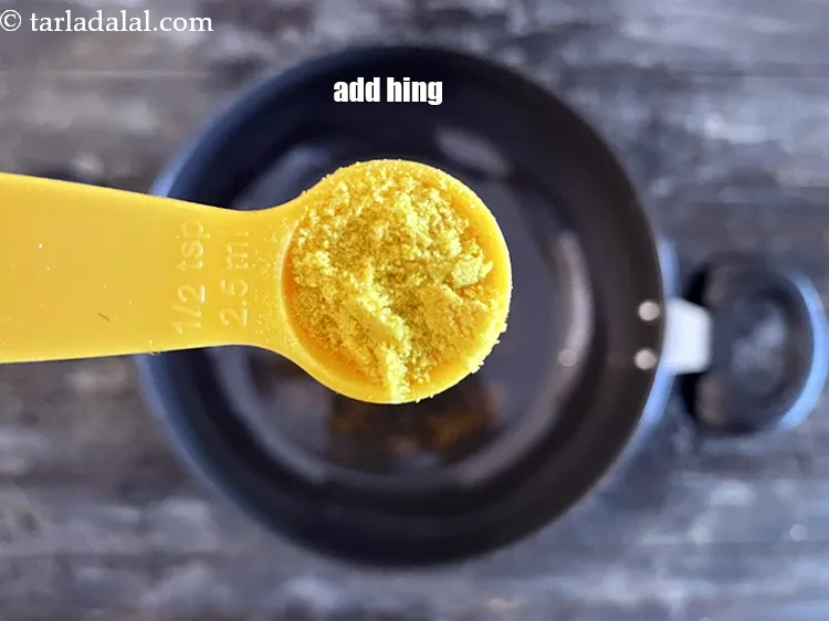 Step 13 – Add&nbsp;<meta charset="UTF-8" />1/2 tsp&nbsp;<a href="glossary-asafoetida-hing-113i">asafoetida (hing)</a>.