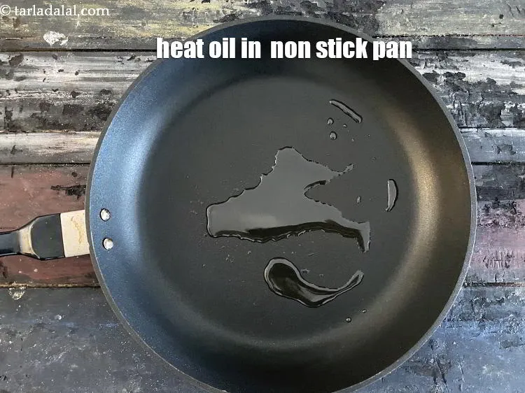 Step 14 – To make&nbsp;paneer capsicum sabzi, heat 1 tsp oil in a deep non-stick kadhai.